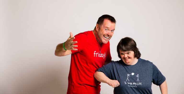 Derrick and Julie having fun smiling at the camera in a silly pose.