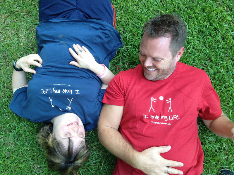 Julie and Derrick on grass laughing together